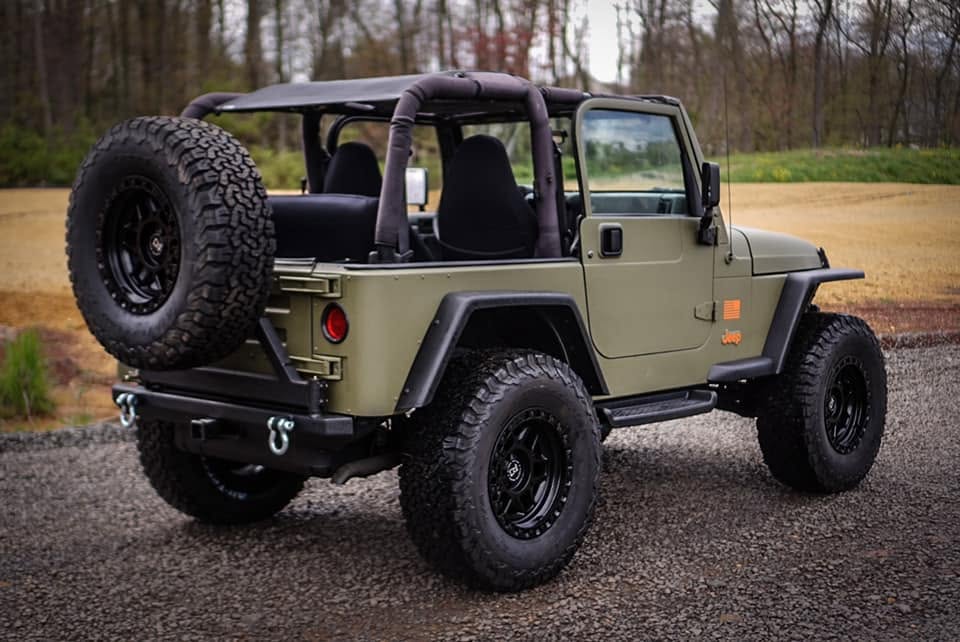 Modified Wrangler-style off-road Jeep photographed on a gravel road
